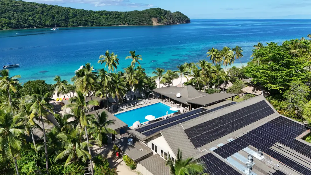 Aerial view of Paradise Cove resort with solar panels and Pacific Ocean