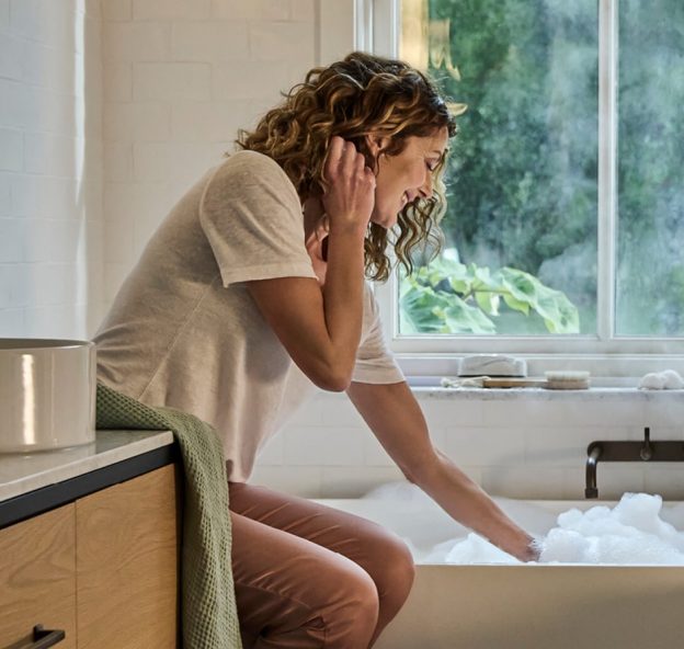 A woman with a hot water heat pump NZ