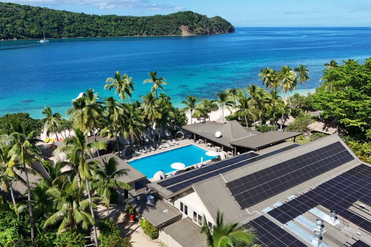 Aerial view of Paradise Cove resort with solar panels and Pacific Ocean